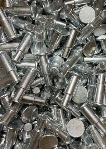 A pile of metal nuts and bolts.